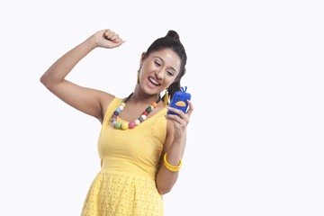 Woman looking at mobile phone and rejoicing