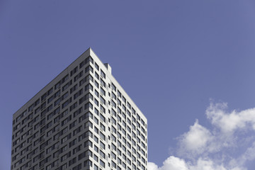 Fototapeta na wymiar A part of modern business building against blue sky