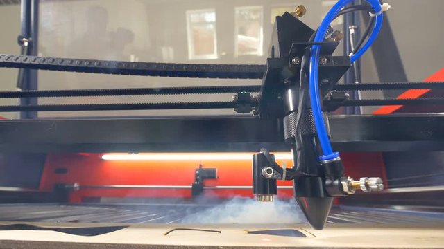 Wood laser cutting machine working. 4K.