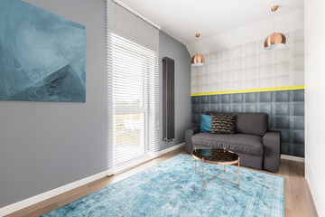 Molding wall and gray couch