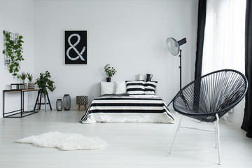 Designed black chair in modern bedroom