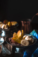 Chocolate mousse with fruits on the wooden table vertical