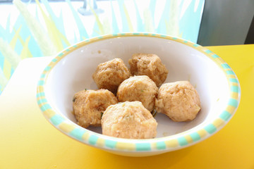 shrimp balls on white bowl and yellow table