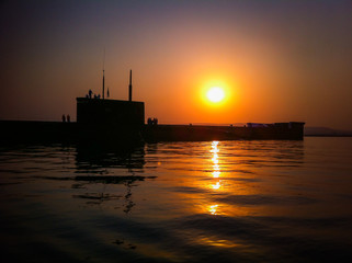 Fototapeta premium Submarine Novorossiysk on the background of sunset