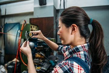 milling machine worker verify manufacturing steel