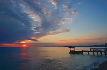 Obraz na płótnie Canvas dramatic sunset with dark clouds over the calm sea