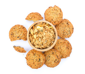 Oatmeal and cookies on white background