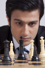 Businessman playing chess