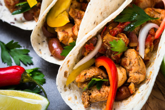 Mexican taco with meat beans and vegetables. Traditional latin american street food menu.
