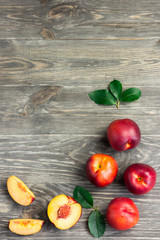 Summer fruits and leaves on wooden background. Top view copy space.