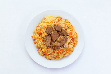 Kazakh plov.
Kazakh national meal plov on a plate on white background.