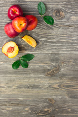 Ripe nectarines on a plate on old garden table. Top view copy space.