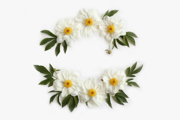 Floral frame wreath made of white peonies, leaves and buds isolated on white background. Flat lay, top view.