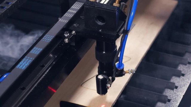 Wood laser cutting machine working. 4K.