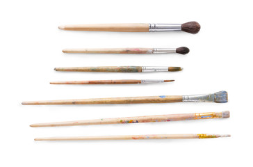 Drawing tools, set of dirty paint brushes in row