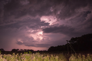 Thunderstorm with lightning on the field