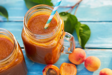 Top view of two glasses of fresh apricot smoothie