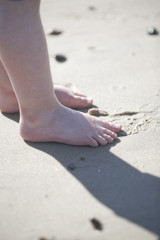 Child's feet in the sand on the beach - 167252210