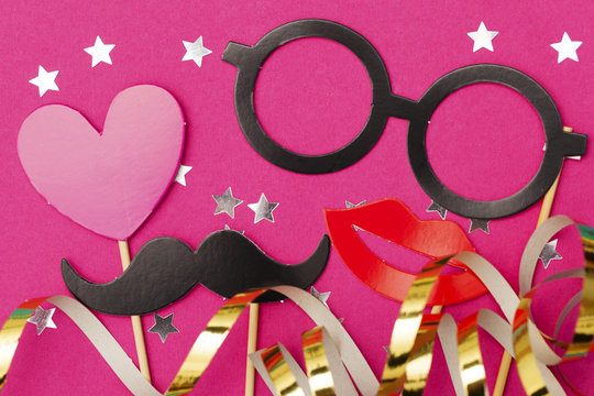 Fun party props on a pink background. Wedding, hen do party photobooth.