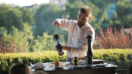 Show Kitchen. The cook prepares Carpaccio for the guests of the restaurant