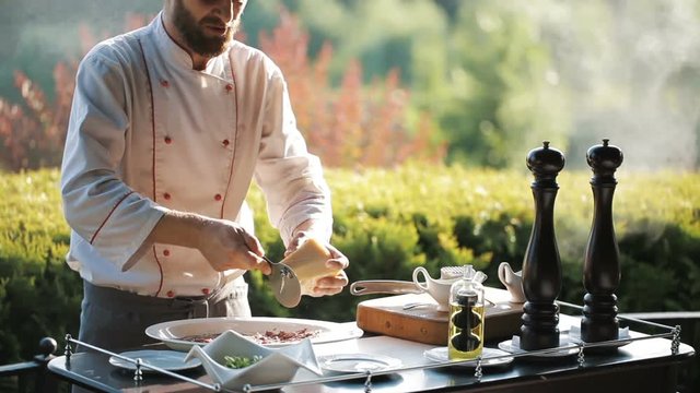 Show Kitchen. The cook prepares Carpaccio for the guests of the restaurant