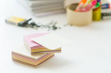 On a white table colorful block for notes