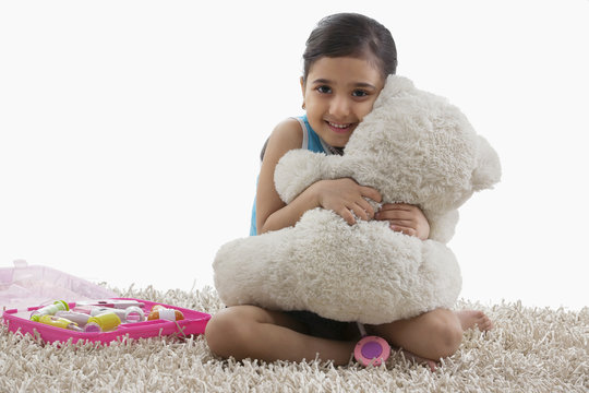 Girl hugging her teddy bear 