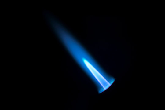 Gas burner flame. Blue fire isolated on black backgroung, close-up