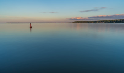 Beautiful Baltic sea landscape with stone breakwater. Tranquil long exposure landscape