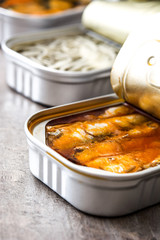 Cans of preserves on wooden table