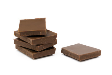 Milk chocolate pieces isolated on white background