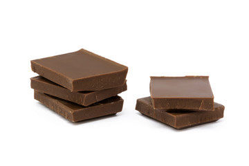 Milk chocolate pieces isolated on white background