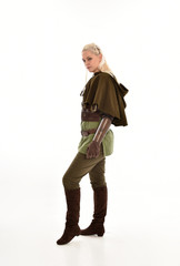 full length portrait of a blonde girl wearing green and brown medieval costume, holding a bow and arrow. isolated on white background.