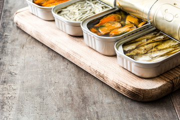 Cans of preserves on wooden table