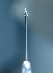 syringe close-up, focus on the drop