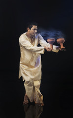 Bengali man doing a Dhunuchi dance 