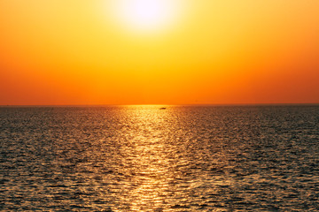 Dawn or sunset on the sea, the ocean, the lake. Beautiful view. The sun is visible.