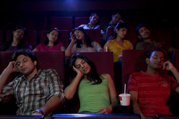 People sleeping inside a cinema hall 