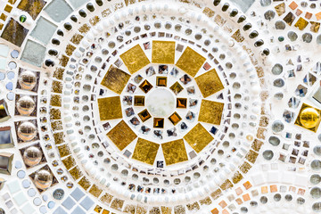 Detail of a beautiful old crumbling abstract ceramic mosaic decoration was destroyed building