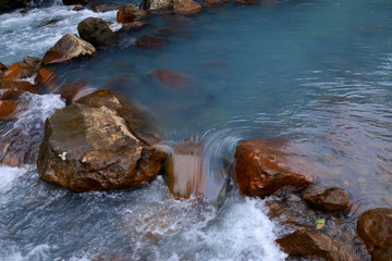blue river in middle of rainforest