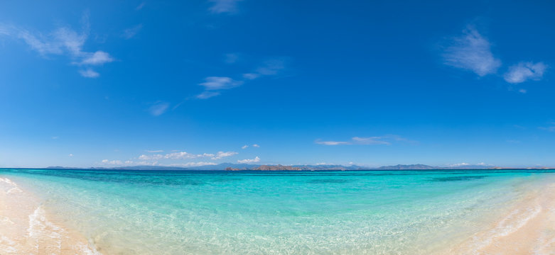 The Beautiful panoramic beach in Kanawa Island, a tropical paradise island in Labuan Bajo, Indonesia. White sand and blue sea for holiday vacation background concept.