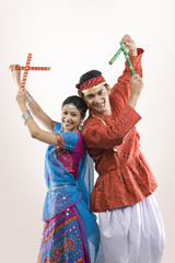 Gujarati couple performing dandiya 