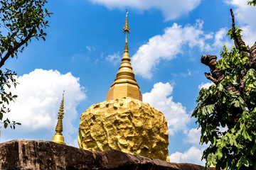 Naklejka premium golden pagoda and golden stone at wat tham pha daen in sakon nakhon thailand.