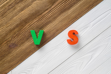 Letters VS on wooden background with copy space.