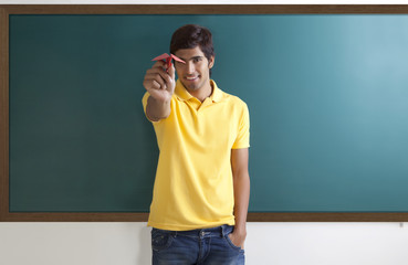 Portrait of a college student with a paper aeroplane