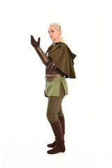full length portrait of a blonde girl wearing green and brown medieval costume, holding a bow and arrow. isolated on white background.