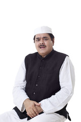 Mature politician sitting over white background 