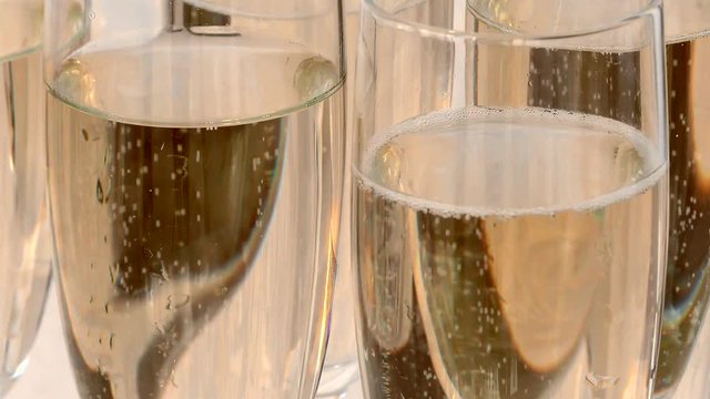 Champagne is bubbling. Glasses with alcohol at the party. Celebration drink at the Banquet.