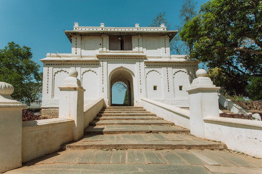 White gates in traditional indian architecture style. Old stairs and arch in historical India