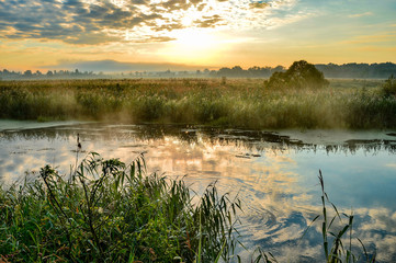 Photo with a sunny summer sunrise over the river